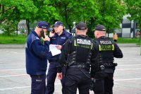 Policjanci rozmawiają przez radiostację.