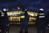 Policjanci obserwują okolicę stadionu piłkarskiego.