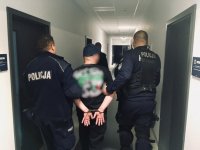 Policjanci prowadzą zatrzymanego.