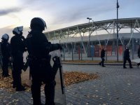 Kordon policjantów prewencji obserwuje okolicę stadionu.