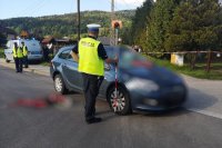 Policjant ruchu drogowego wykonuje pomiary na miejscu wypadku.