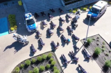 Policjanci wykonują pompki przed budynkiem komendy