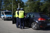 Policjanci rozmawiają z kontrolowanym kierowcą.