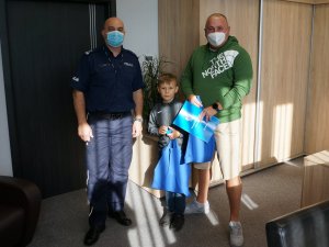 I Zastępca Komendanta Miejskiego Policji w Bielsku-Białej na wspólnej fotografii z panem Maciejem oraz 8-letnim chłopcem w gabinecie.